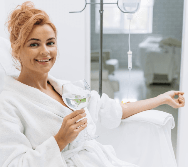 happy-woman-white-bathrobe-holding-glass
